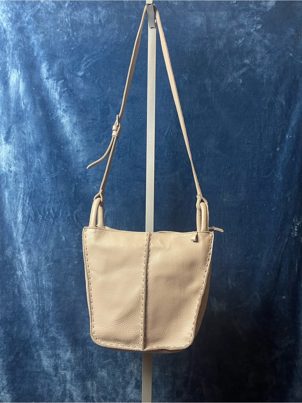 The Sak Los Feliz Slouchy Crossbody bag in a light sand-colored leather.